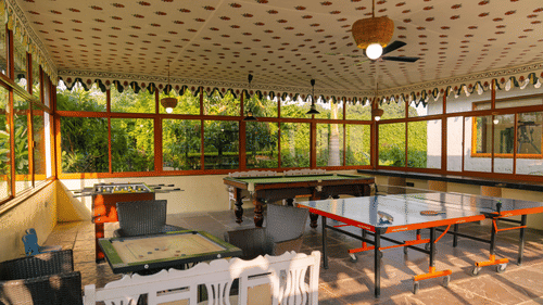 Games room with various games including a carom board, table tennis, billiards, and foosball